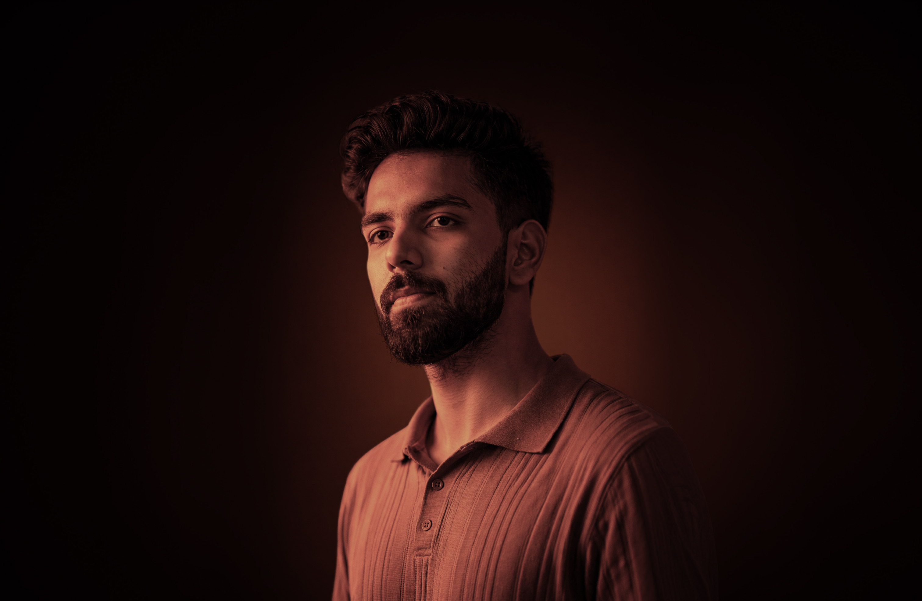 M. Awais portrait with warm amber spotlight